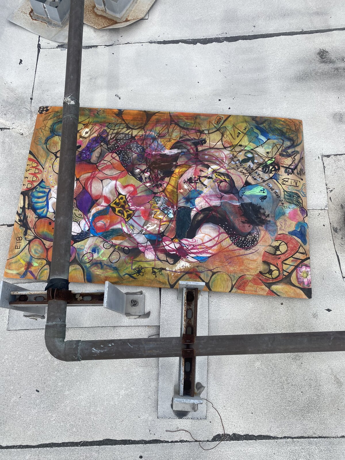 A large colorful collaborative painting seen from above