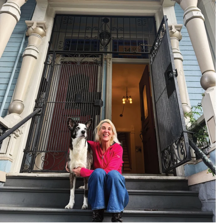 Portrait photograph of Lisa Zahner seated outside a Lower Haight home.